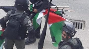 الاحتلال يزيل أعلام فلسطين والفصائل من العيساوية